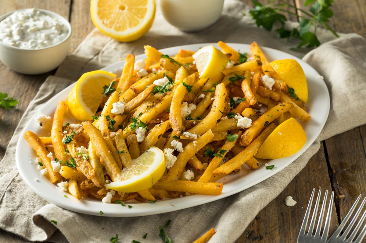CISSNE'S loaded hand-cut fries topped with feta and a drizzle of house tzatziki